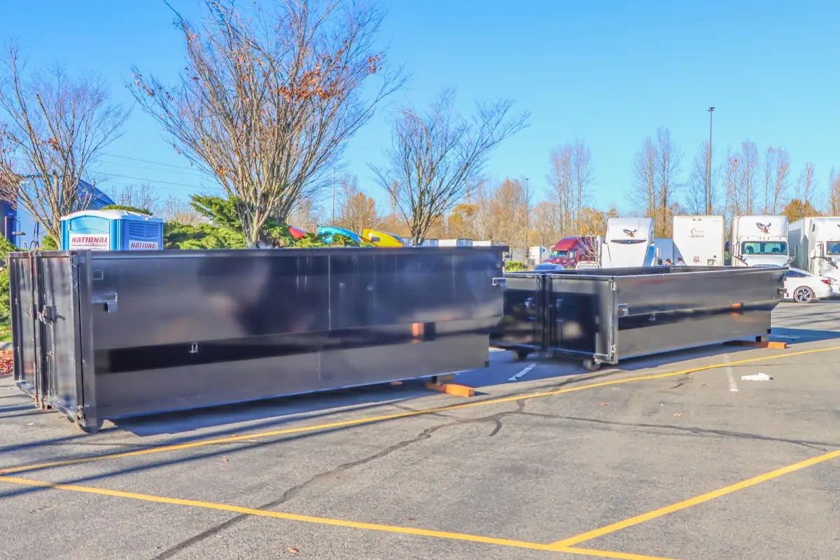 Professional dumpster rental service with roll-off container on residential driveway in Attalla